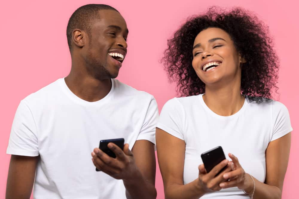 Two people enjoying their iphones